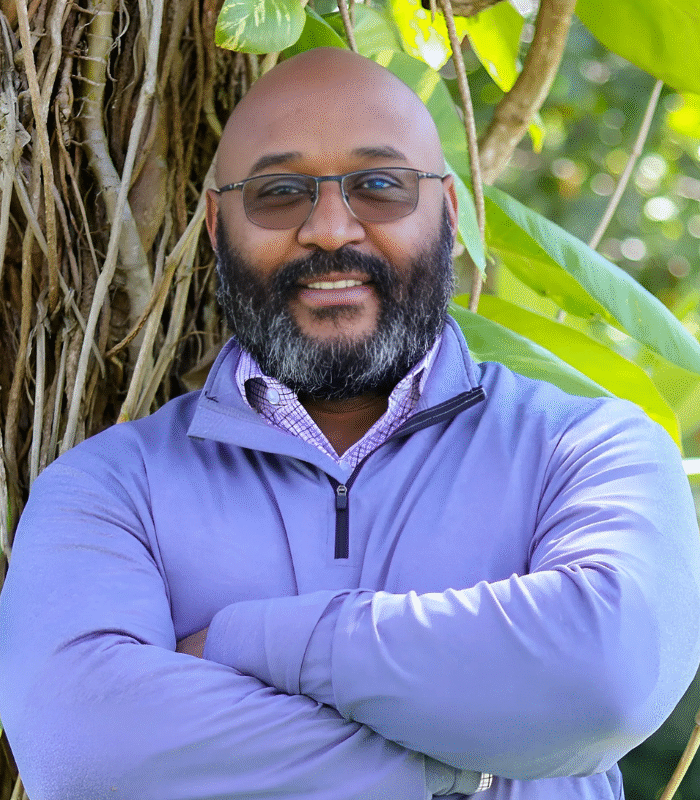 Portrait of Omar Ferreira, Psychospiritual Leadership Guide and Co-Founder of ASQ Empowerment, standing confidently by a tree in nature