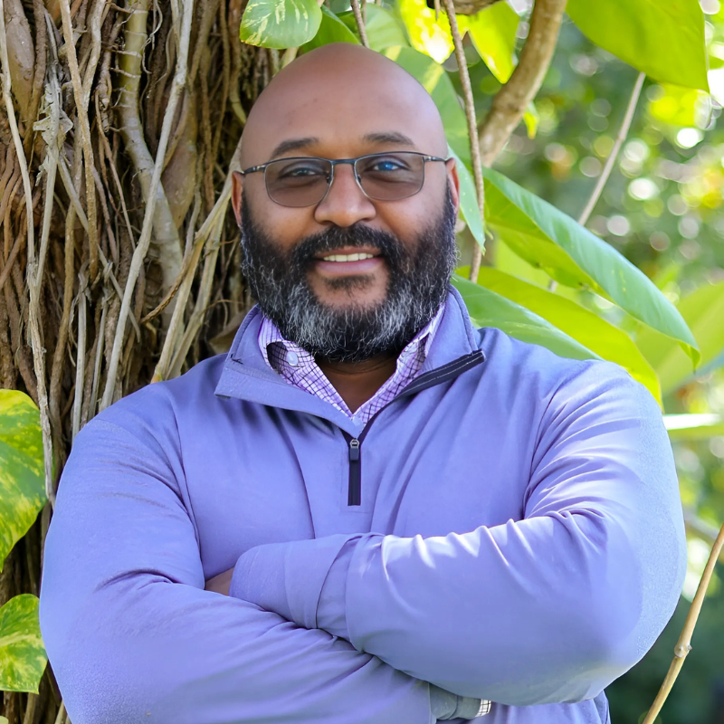 Portrait of Omar Ferreira, Psychospiritual Leadership Guide and Co-Founder of ASQ Empowerment, standing confidently by a tree in nature